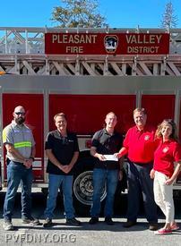 Cliff Weigelt, Kevin McCarthy, Greg Peckham (center) present Fire Commissioners Jim Albrecht, and Melissa Lawlor the check. 