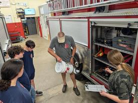 Lieutenant Burgess describes the use of firefighter decontamination (decon) supplies and the importance of proper decontamination after a fire